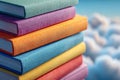 Stack of colorful hardcover books with fabric texture against a dreamy sky background featuring soft, fluffy clouds on a bright Royalty Free Stock Photo