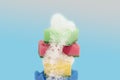 Stack of colorful kitchen cleaning sponges with soap bubbles on blue background Royalty Free Stock Photo