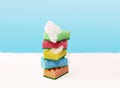 Stack of colorful kitchen cleaning sponges with soap bubbles on blue background Royalty Free Stock Photo