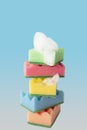 Stack of colorful kitchen cleaning sponges with soap bubbles on blue background Royalty Free Stock Photo