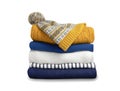 Stack of colorful knitted folded clothes isolated on white. Winter apparel,yellow blue knitwear Royalty Free Stock Photo