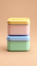 Colorful Stacked Storage Boxes on Beige Background for Organizing and Decorating Royalty Free Stock Photo