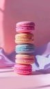 Stack of colorful macarons on pink background with soft lighting, sweet and delicate dessert concept Royalty Free Stock Photo