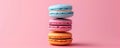 Stack of colorful macarons on a pink background, sweet dessert concept Royalty Free Stock Photo