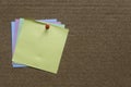 A stack of colorful memo notes on a notice cork board.Copy space for text,logo Royalty Free Stock Photo