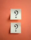 Paper notes with question marks on Coral background, flat lay. Space for text Royalty Free Stock Photo