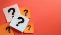 Paper notes with question marks on Coral background, flat lay. Space for text Royalty Free Stock Photo