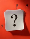 Paper notes with question marks on Coral background, flat lay. Space for text Royalty Free Stock Photo
