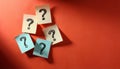 Paper notes with question marks on Coral background, flat lay. Space for text Royalty Free Stock Photo
