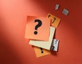 Paper notes with question marks on Coral background, flat lay. Space for text Royalty Free Stock Photo