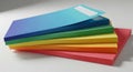 A stack of colorful notebooks is arranged on a white surface. The notebooks are in vibrant hues: Royalty Free Stock Photo