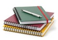 Stack of colorful notebooks with a pen on top Royalty Free Stock Photo