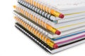 Stack of colorful notebooks with pencils isolated on white. Royalty Free Stock Photo