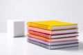 Stack of Colorful Notebooks on a Table With a Cube Royalty Free Stock Photo