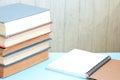 Stack of colorful old hardback books with brown notebook. Many Books Piles Royalty Free Stock Photo