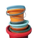 Stack of colorful old rusty buckets isolated cut out on white, cleaning equipments Royalty Free Stock Photo