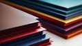 A stack of colorful papers on a table with white background, AI Royalty Free Stock Photo