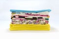 A stack of colorful pillowcases over a white background