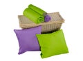 Stack of colorful pillows and twisted blankets on basket