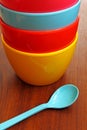 Stack of colorful plastic bowl with blue spoon Royalty Free Stock Photo