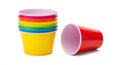 Stack of colorful plastic cups and one red cup lying on its side on a white background image photo Royalty Free Stock Photo