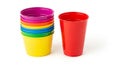Stack of Colorful Plastic Cups and a Single Red Cup on White Background colorful cups party cups Royalty Free Stock Photo