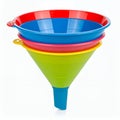 Colorful plastic funnels stacked, vibrant kitchen aid arrangement isolated on white background Royalty Free Stock Photo