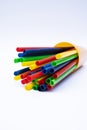 Stack of colorful plastic straws in a cup with white background Royalty Free Stock Photo
