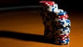 A stack of colorful poker chips on a wooden table in a casino Royalty Free Stock Photo