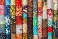 Stack of colorful quilting batik fabrics as a vibrant background image