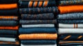 A stack of colorful scarves in various shades of orange, blue, and gray. Royalty Free Stock Photo