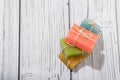 Stack of colorful scented soap bars with brown ribbon on wooden background Royalty Free Stock Photo