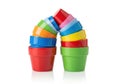 Stack of colorful small plastic flower pots arranged in an arch shape isolated on white background Royalty Free Stock Photo