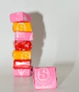 A stack of colorful Starburst candy with a pink on isolated in the front