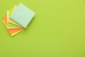 Stack of colorful stickers on light green background, top view. Space for text Royalty Free Stock Photo