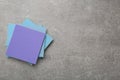 Stack of colorful stickers on light grey stone table, top view. Space for text Royalty Free Stock Photo