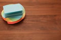 Stack of colorful stickers on wooden table, space for text Royalty Free Stock Photo