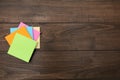 Stack of colorful stickers on wooden table, top view. Space for text Royalty Free Stock Photo