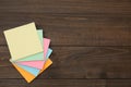 Stack of colorful stickers on wooden table, top view. Space for text Royalty Free Stock Photo