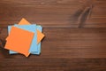 Stack of colorful stickers on wooden table, top view. Space for text Royalty Free Stock Photo