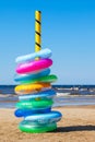 Stack of colorful swimming rings on sea beach Royalty Free Stock Photo