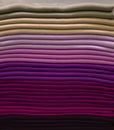 Stack of colorful t-shirts. Layers of colorful fabric. Stack of colorful folded clothes, multicolored background