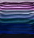 Stack of colorful t-shirts. Layers of colorful fabric. Stack of colorful folded clothes, multicolored background