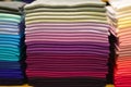 Stack of colorful t-shirts. Layers of colorful fabric. Stack of colorful folded clothes, multicolored background