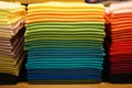 Stack of colorful t-shirts. Layers of colorful fabric. Stack of colorful folded clothes, multicolored background