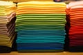 Stack of colorful t-shirts. Layers of colorful fabric. Stack of colorful folded clothes, multicolored background Royalty Free Stock Photo