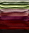 Stack of colorful t-shirts. Layers of colorful fabric. Stack of colorful folded clothes, multicolored background Royalty Free Stock Photo