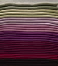 Stack of colorful t-shirts. Layers of colorful fabric. Stack of colorful folded clothes, multicolored background