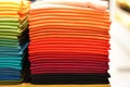 Stack of colorful t-shirts. Layers of colorful fabric. Stack of colorful folded clothes, multicolored background Royalty Free Stock Photo