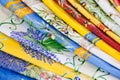 A stack of colorful tablecloths at a weekly market in Provence, France Royalty Free Stock Photo